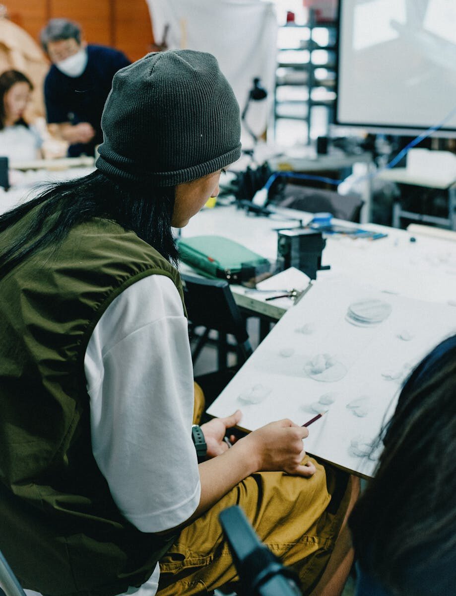 Students engaged in an art class in Shinjuku, Tokyo, showcasing creativity and collaboration.