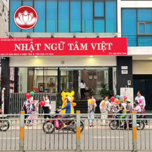 People with balloons gather outside Nhat Ngu Tam Viet school in Ho Chi Minh City