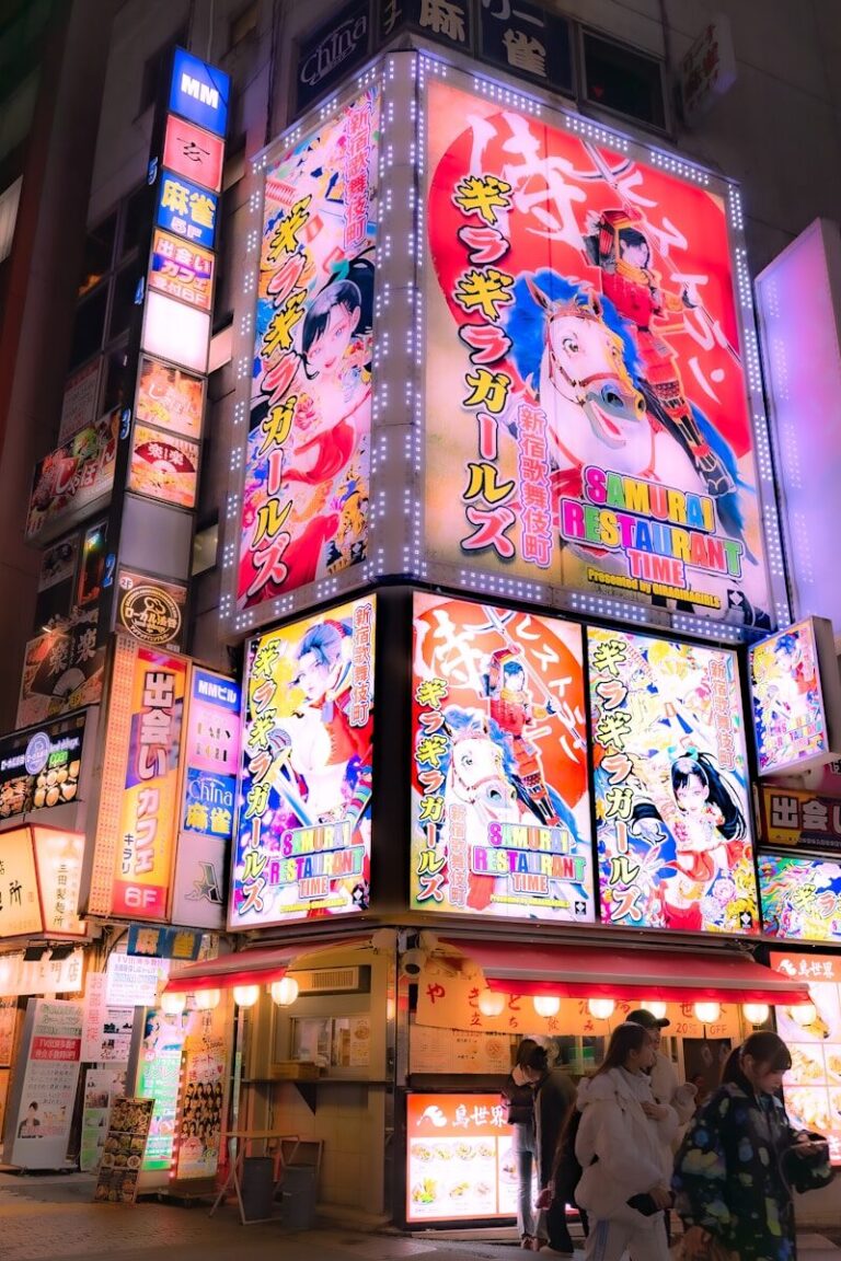 Nighttime in japan with bright, colorful signs.